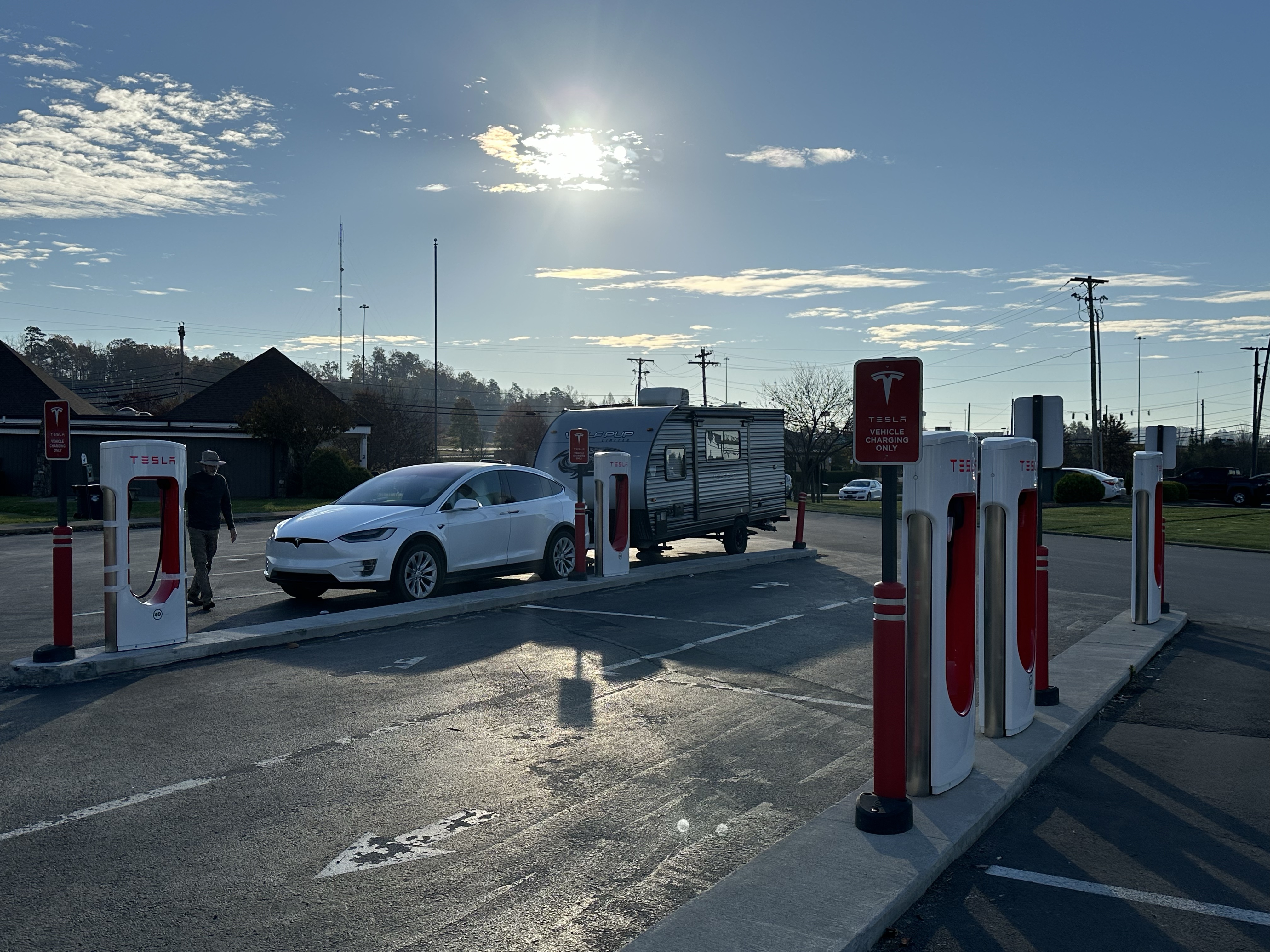 Tesla Model X pulling camper at SuperCharger. Picture by Happy Vegan Campers.