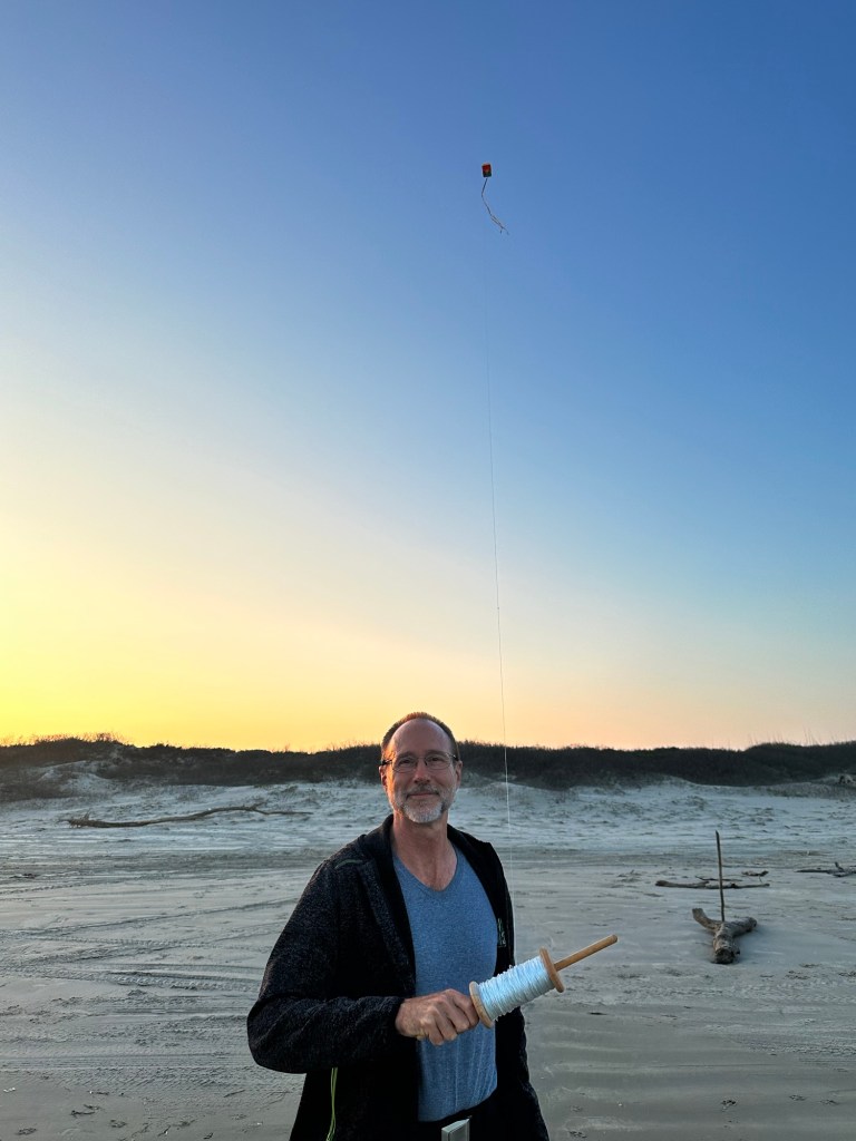 Daniel flying a kite at Mustang Island State Park beach in Corpus Christi, Texas. Picture by Happy Vegan Campers.