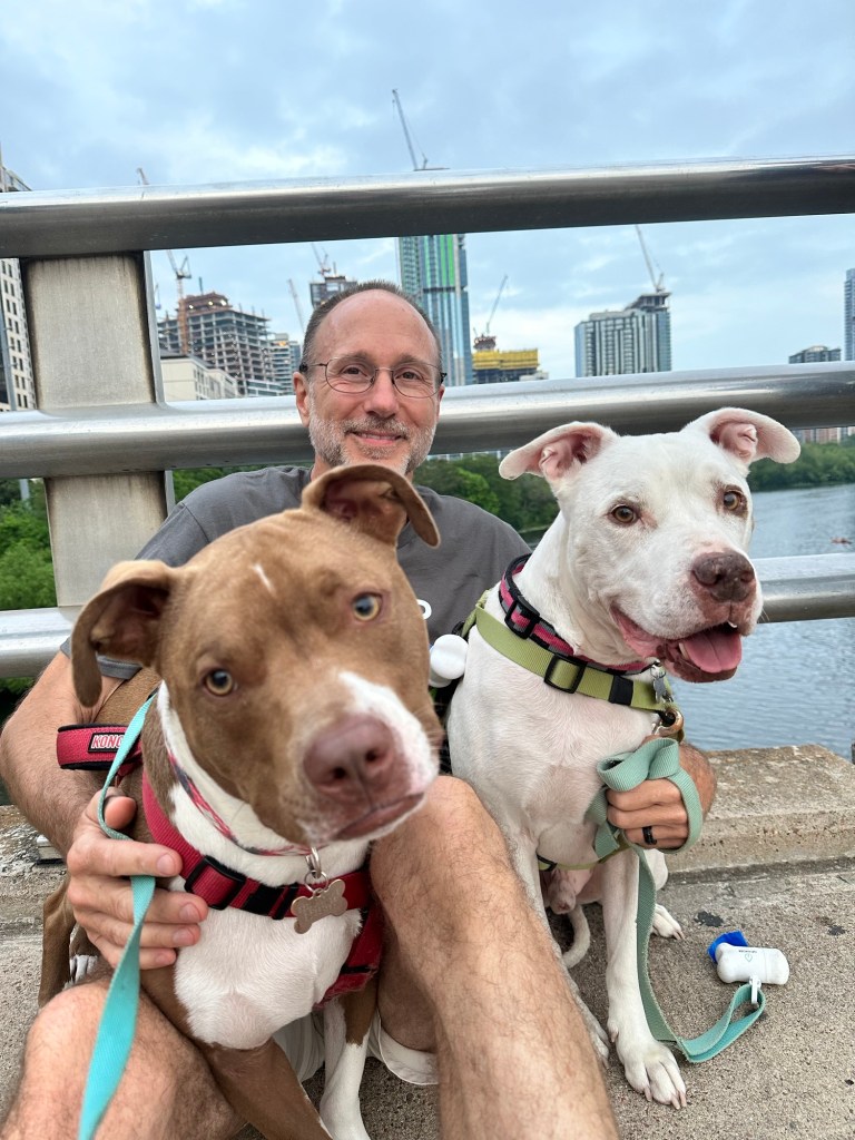 Happy Vegan Campers with dogs on bridge in Austin Texas