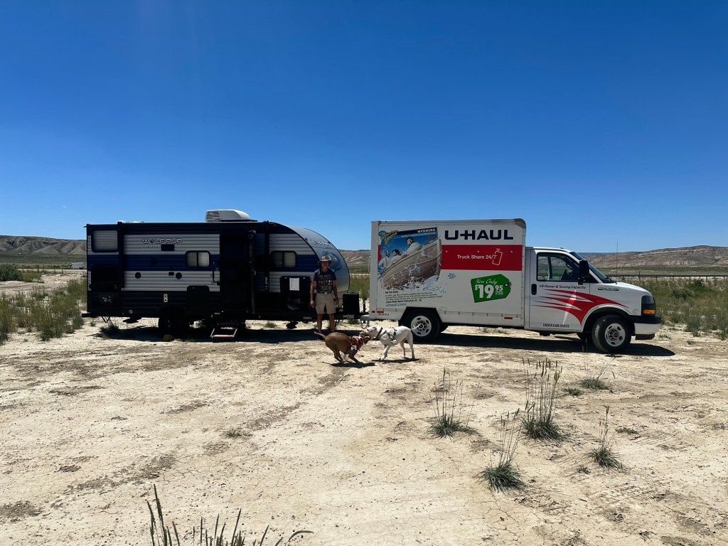 Happy Vegan Campers camper being towed with U-Haul