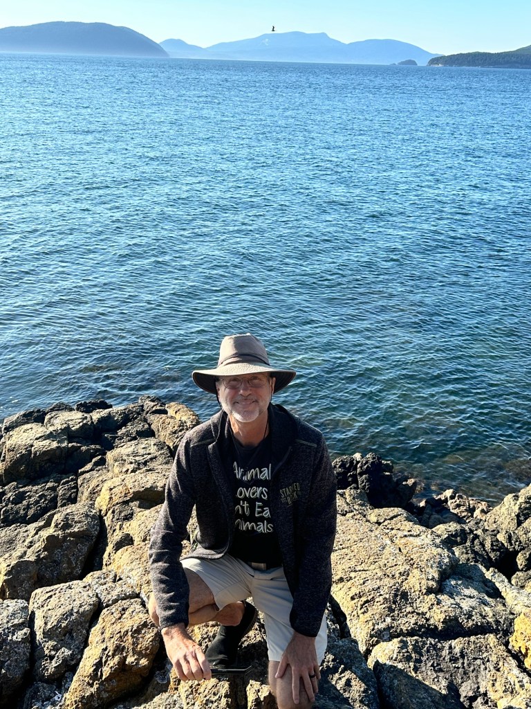 Daniel on the earth’s mantle at Washington Park in Anacortes, Washington by Happy Vegan Campers
