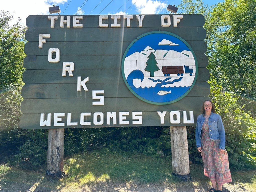 Kristin and Forks sign in Forks, Washington by Happy Vegan Campers
