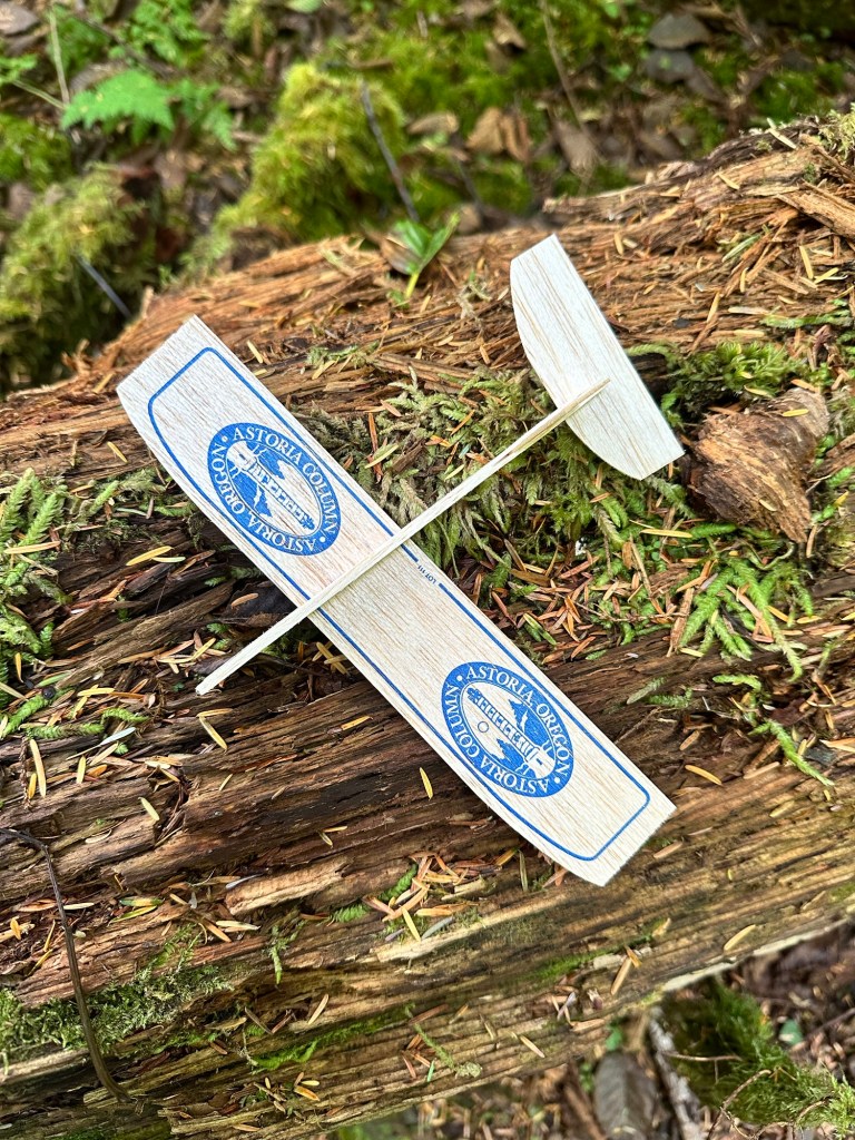 Wooden airplane thrown off of Astoria Tower in Astoria, Oregon by Happy Vegan Campers