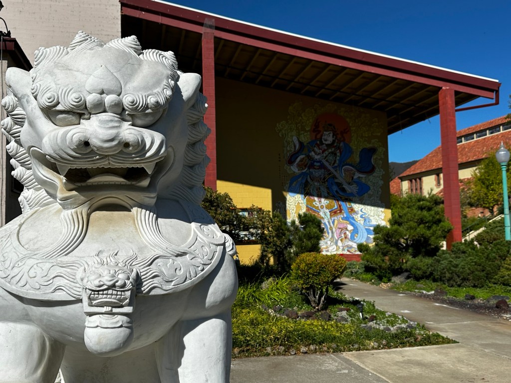 Statue and mural at City of Ten Thousand Buddhas in Ukiah, California by Happy Vegan Campers