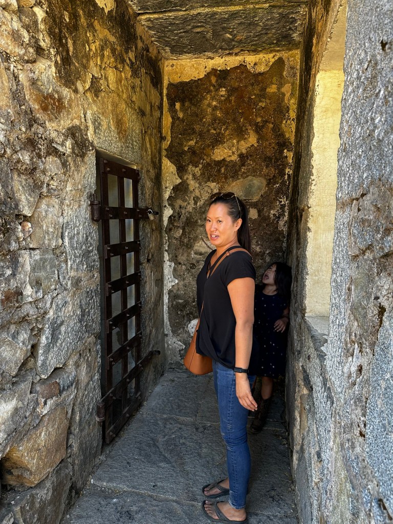 Kim and Kavelia looking in an 1860s jail in Coloma, California by Happy Vegan Campers