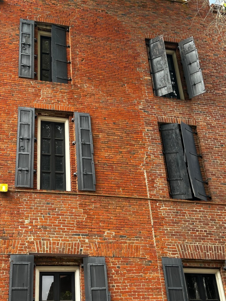 Brick building with metal shutters in Old Sacramento, California by Happy Vegan Campers