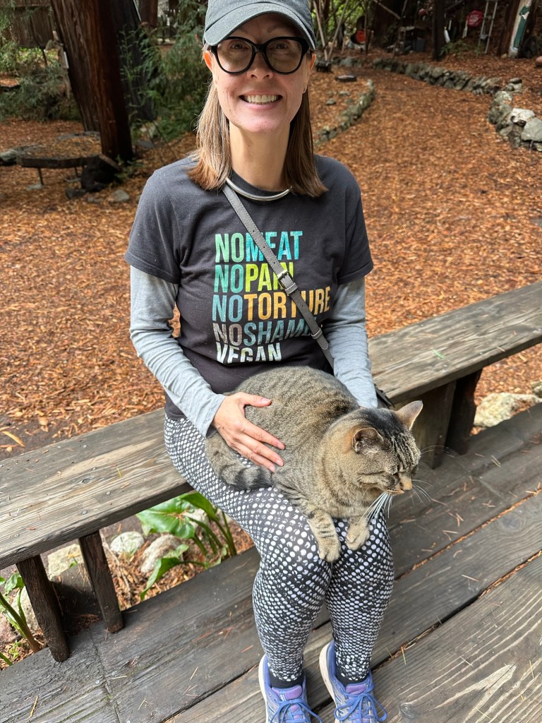Kristin with cat friend at Henry Miller Memorial Library in Big Sur, California. Picture by Happy Vegan Campers.
