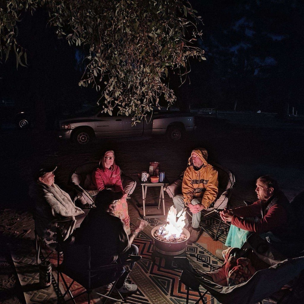 Friends around campfire in Acton, California.