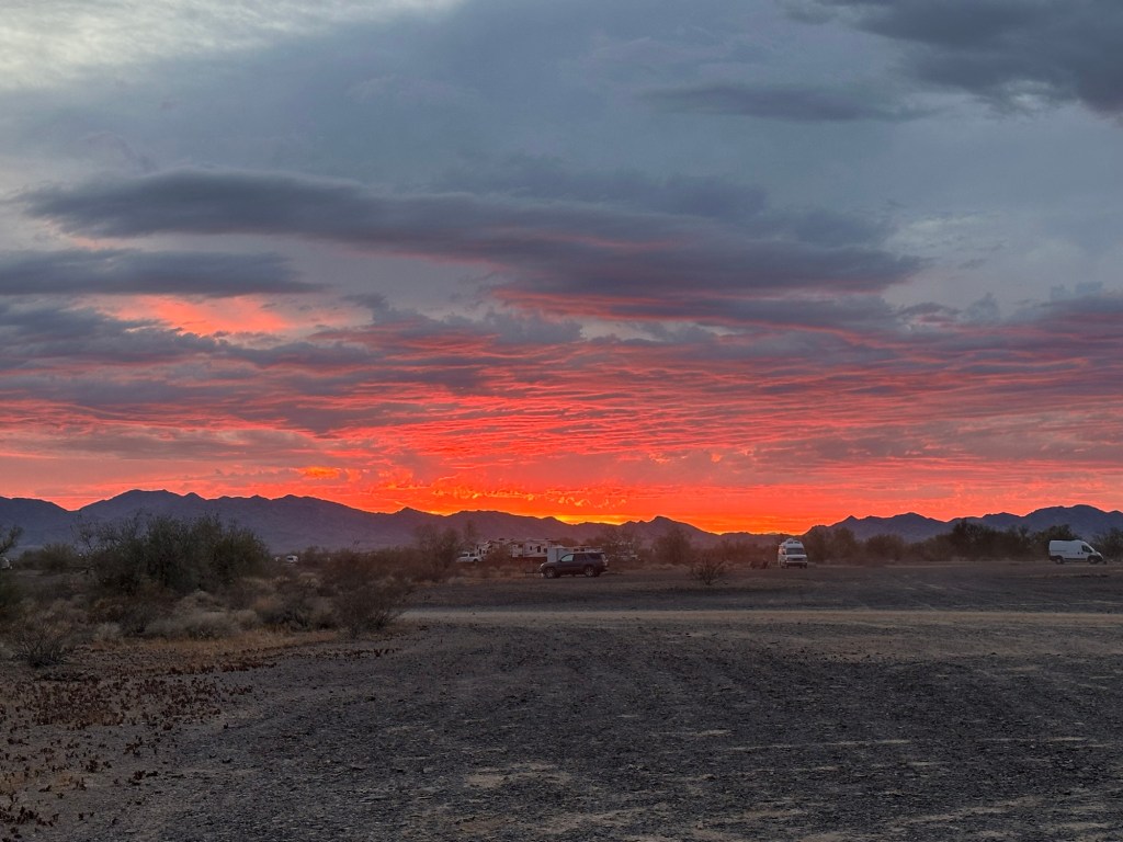 Sunset at Rolling Vegan Rendezvous on BLM land in Quartzsite, Arizona. Picture by Happy Vegan Campers.