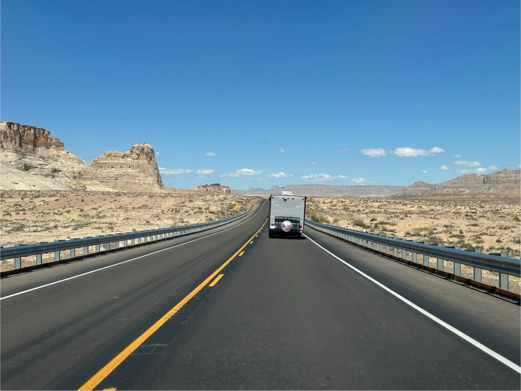 Camper driving down road in Utah. Picture by Happy Vegan Campers.