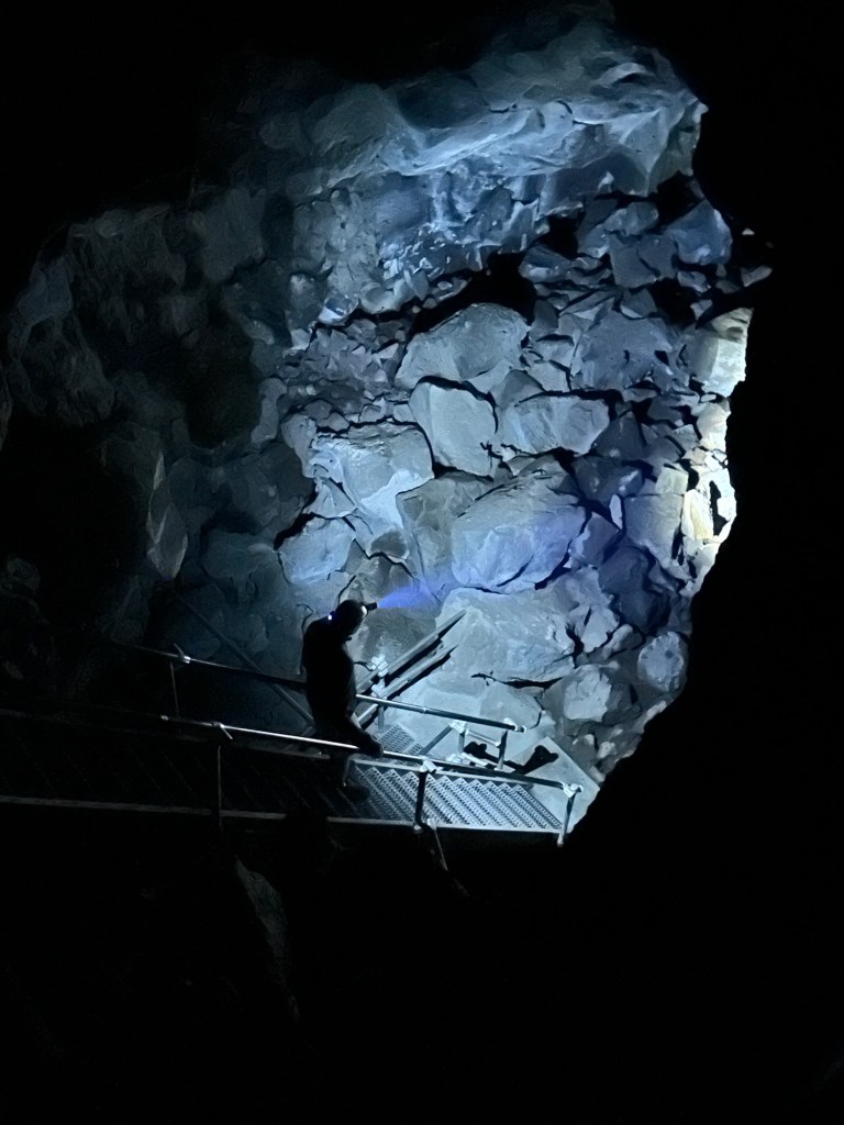 Daniel going down stairs in Skull Cave at Lava Beds National Monument in Tulelake, California. Picture by Happy Vegan Campers.
