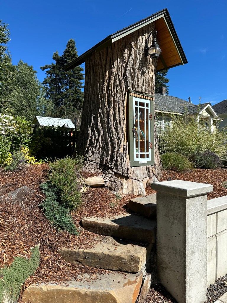Little Library built in tree trunk in Coeur d'Alene, Idaho. Picture by Happy Vegan Campers.