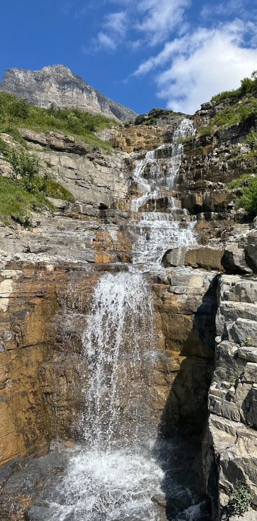 View of waterfall from Going-To-The-Sun Road in Glacier National Park in Montana, USA. Picture by Happy Vegan Campers.