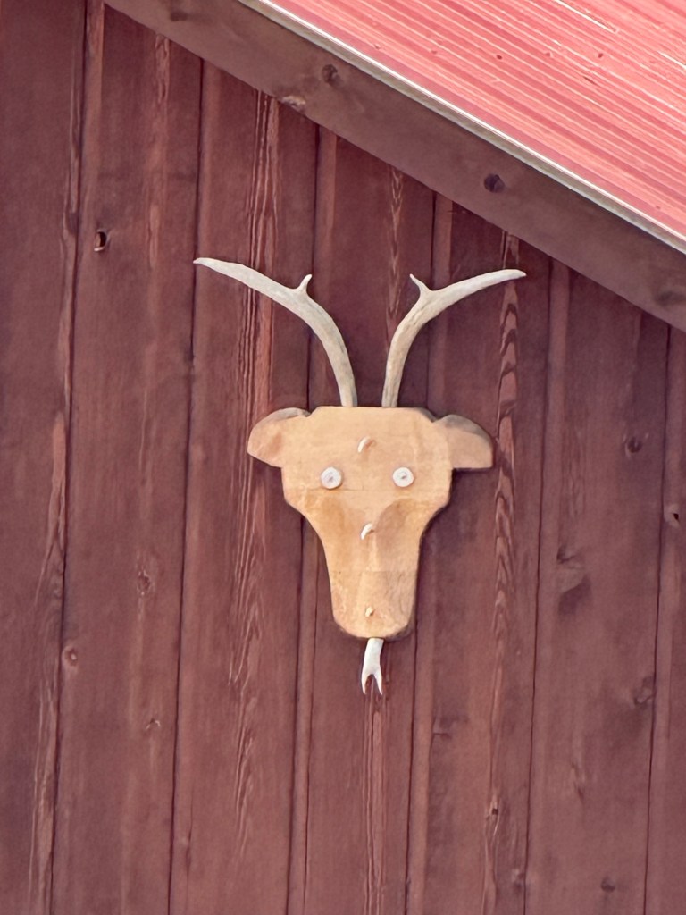Wooden deer head on barn in Cooke City, Montana, USA.
