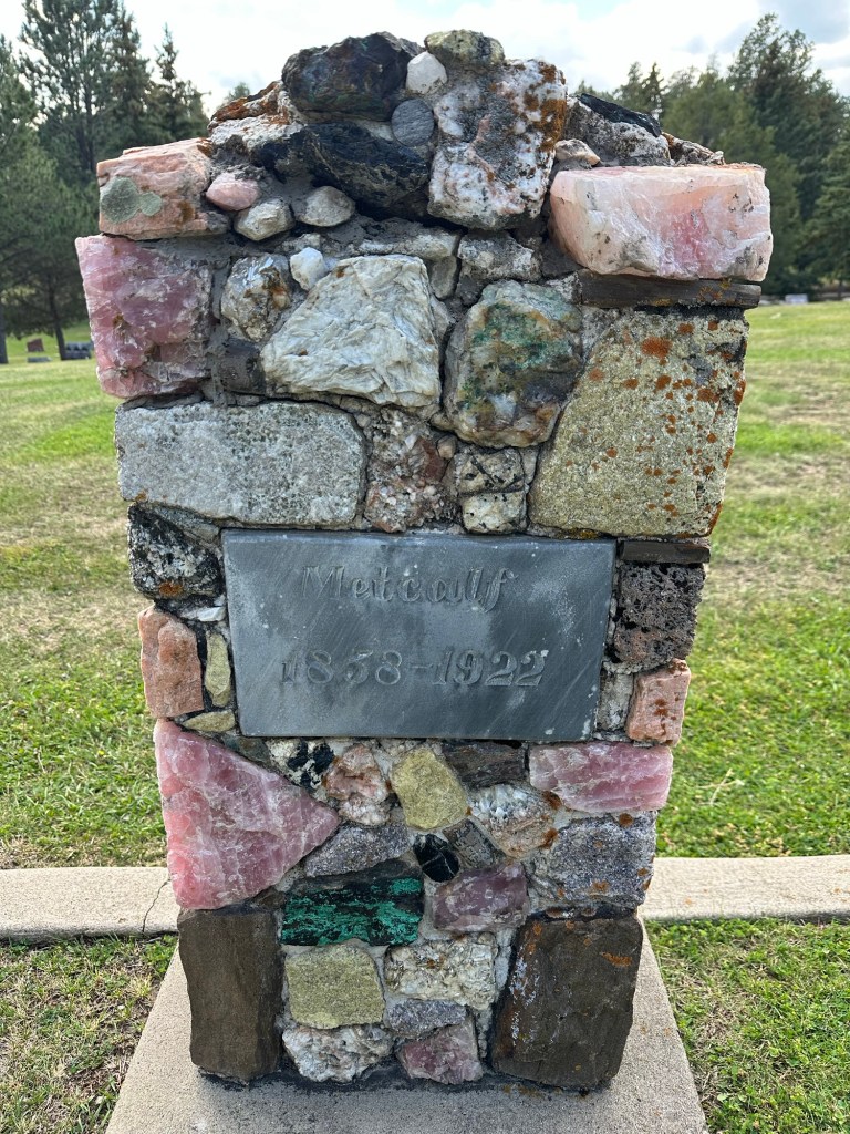 Petrified wood and gemstone headstone in Custer Cemetery in Custer, South Dakota, USA.