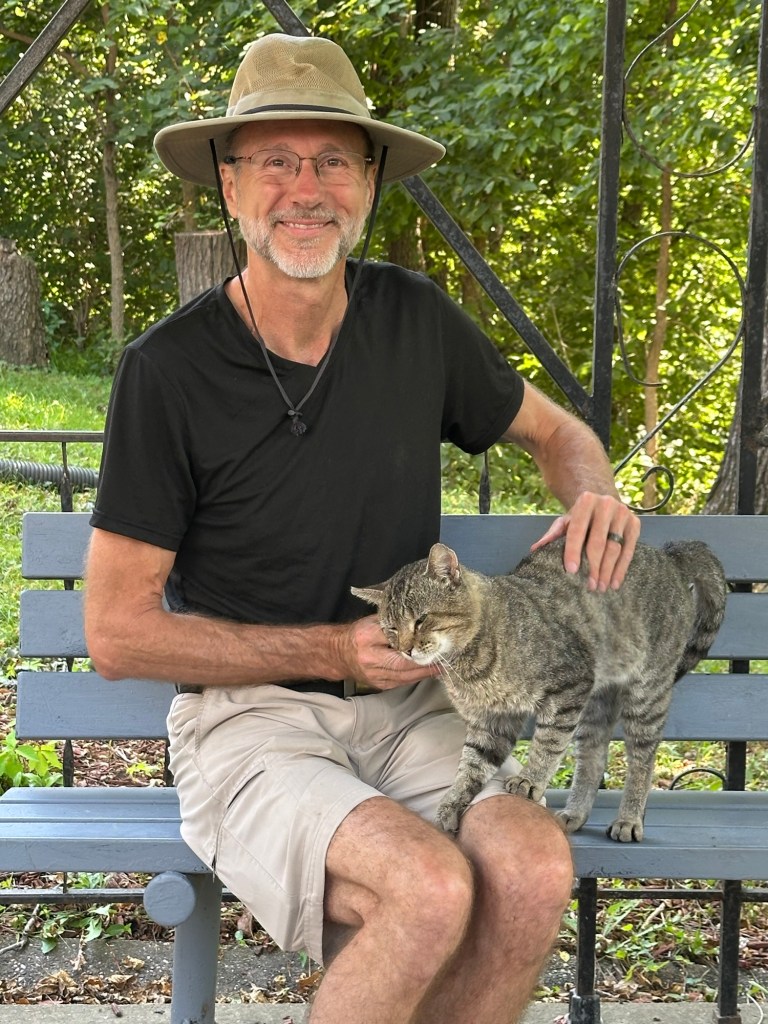 Daniel and friendly cat at Lover’s Leap Bridge in Columbus Junction, Iowa, USA.
