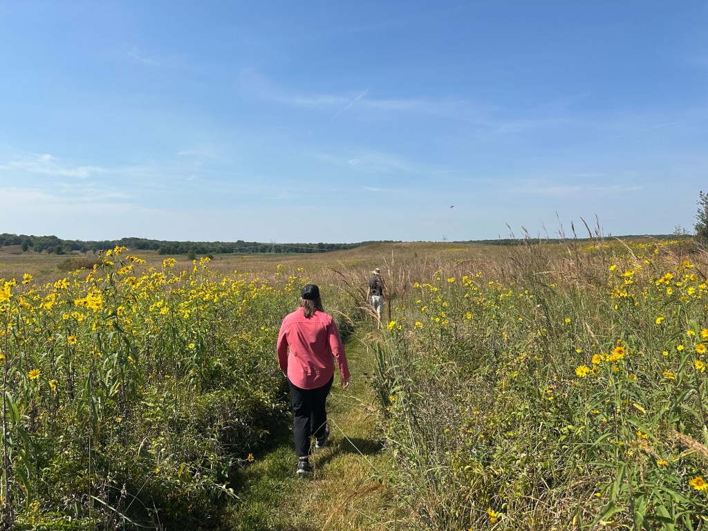 MacKenzie and Daniel walking on trail in Nachusa Grasslands in Franklin Grove, Illinois, USA.