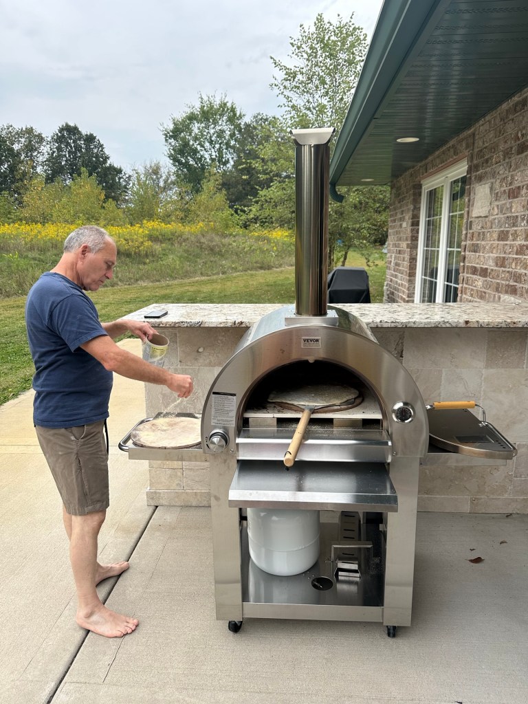 Larry making pizzas in a pizza oven in Crown Point, Indiana, USA.
