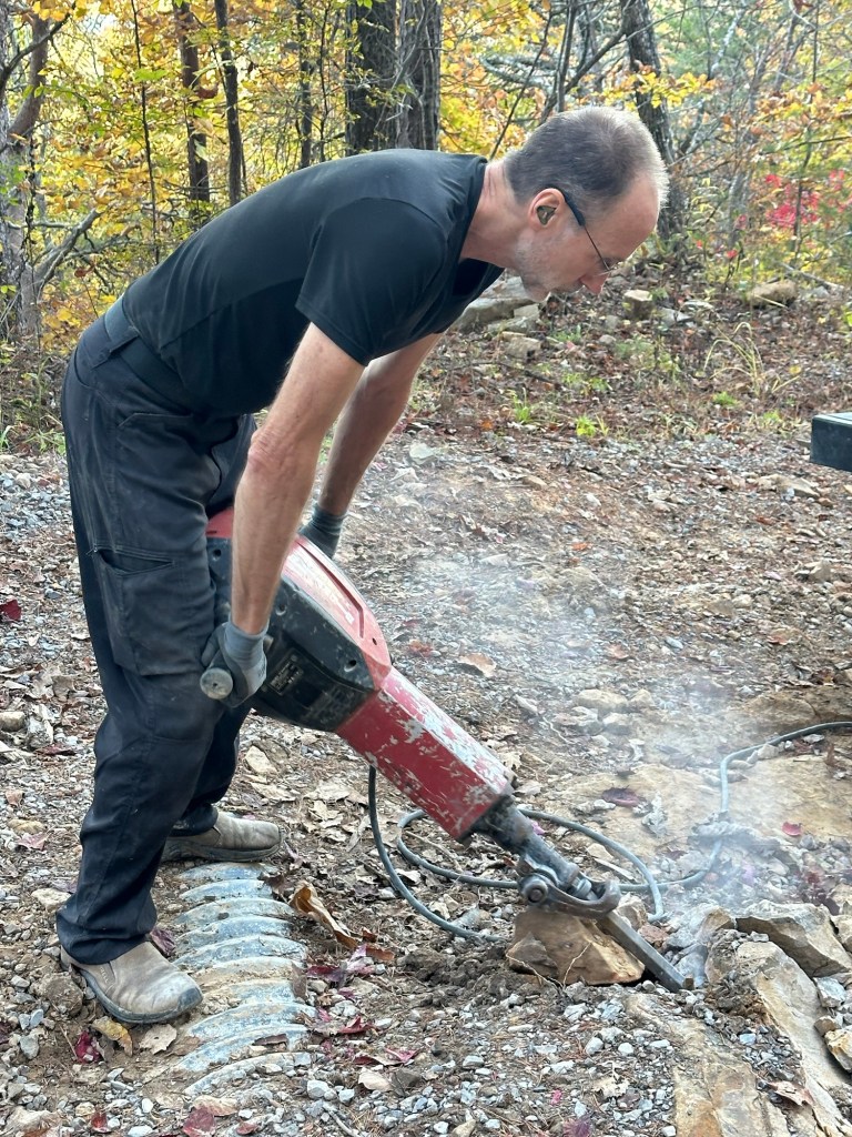 Daniel Dubay using a jackhammer to break up boulders on a road in Dunlap, Tennessee, USA.