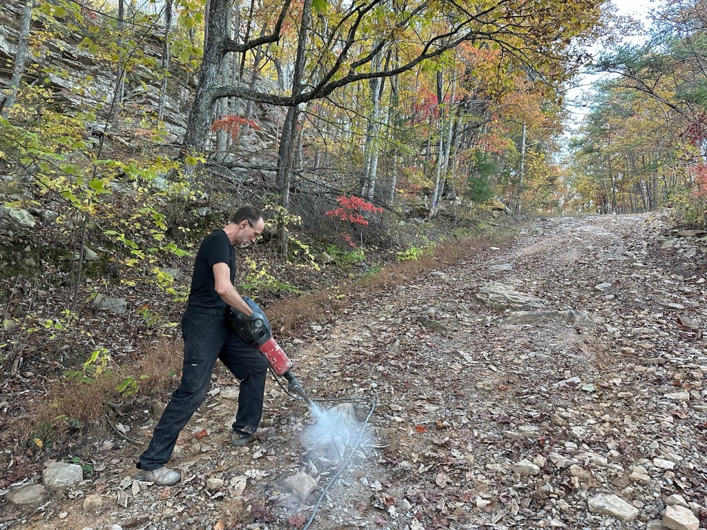 Daniel Dubay using a jackhammer to break up boulders on a road in Dunlap, Tennessee, USA.