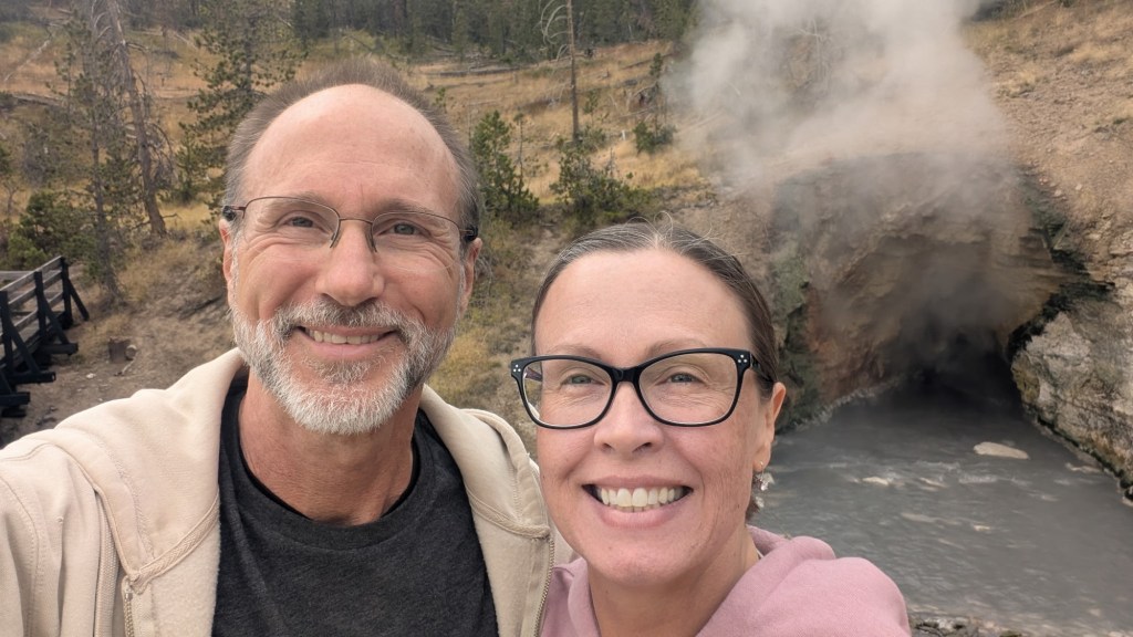 Daniel and Kristin by Dragon’s Mouth Spring in Yellowstone National Park in Wyoming, USA.