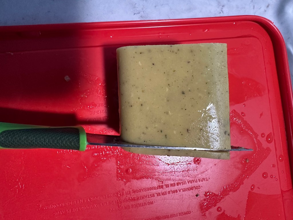 Lentil mixture being sliced into 3 mm slices for lentil crackers.
